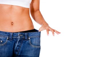 Woman Holding Out Pants Showing Weight Loss