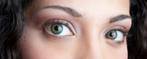 Eyes close up of beautiful brunette curly girl.