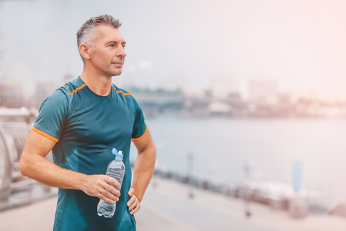 healthy athletic middle aged man with fit body holding bottle of refreshing water,-img-blog