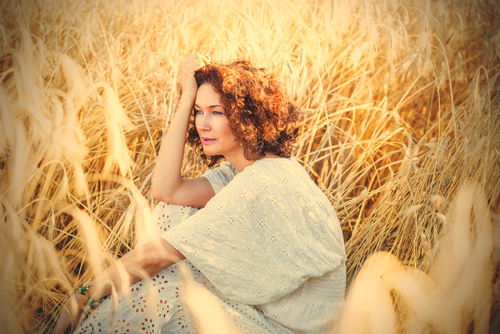 image of middle aged beautiful woman smiling in a wheat field-img-blog