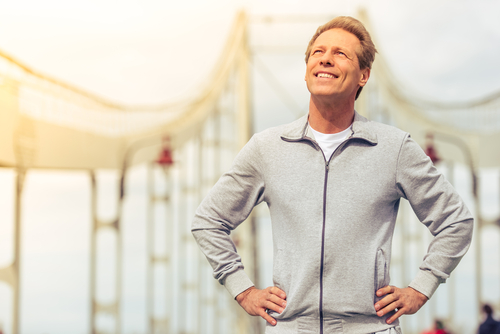 handsome middle aged man in sports uniform is looking upward and smiling-img-blog