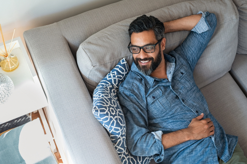 mature man resting on sofa and being happy -img-blog